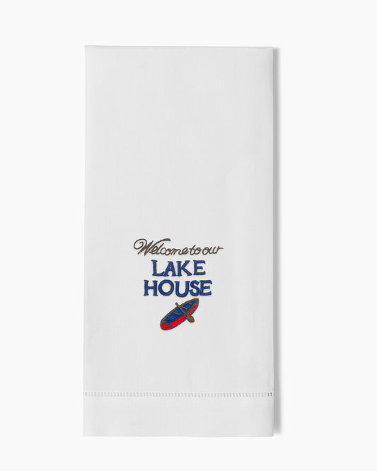 A white Henry Handwork towel that says Welcome to our Lake House.