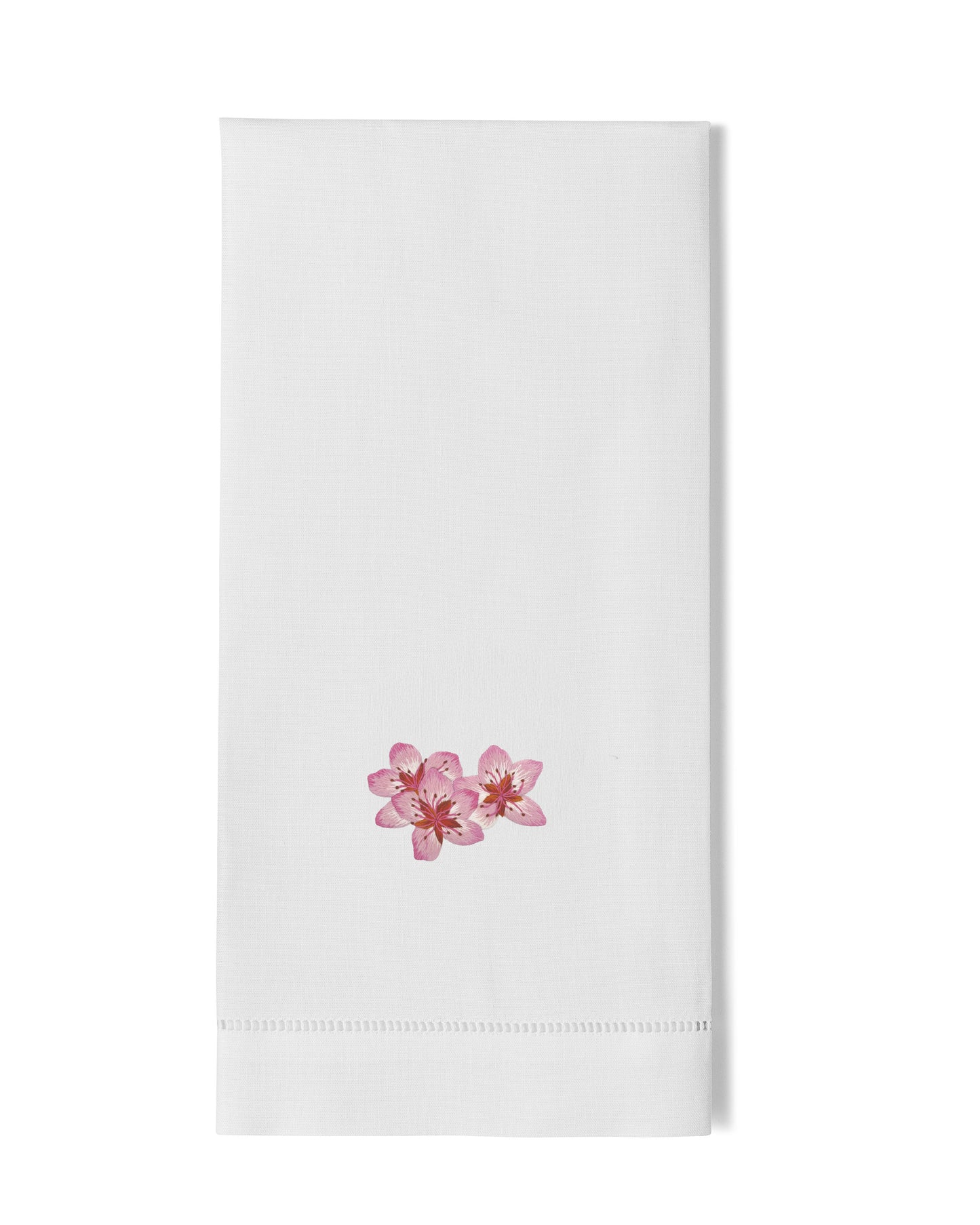 White towel with embroidered pink floral embroidery on a white background