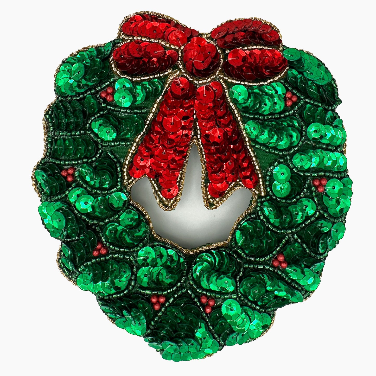 Image of a holly wreath Christmas ornament with intricate beadwork.
