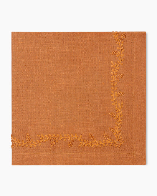 A Prism Vine Linen Dinner Napkin in 13 Colors with gold embroidery by Henry Handwork, perfect for table linens.
