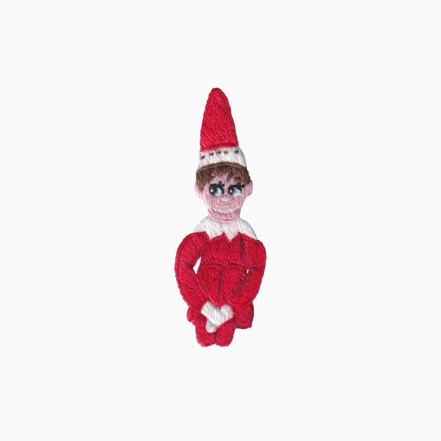 Hand embroidered cotton boutique tissue box cover of Elf on the Shelf toy wearing a red outfit and hat on a white background