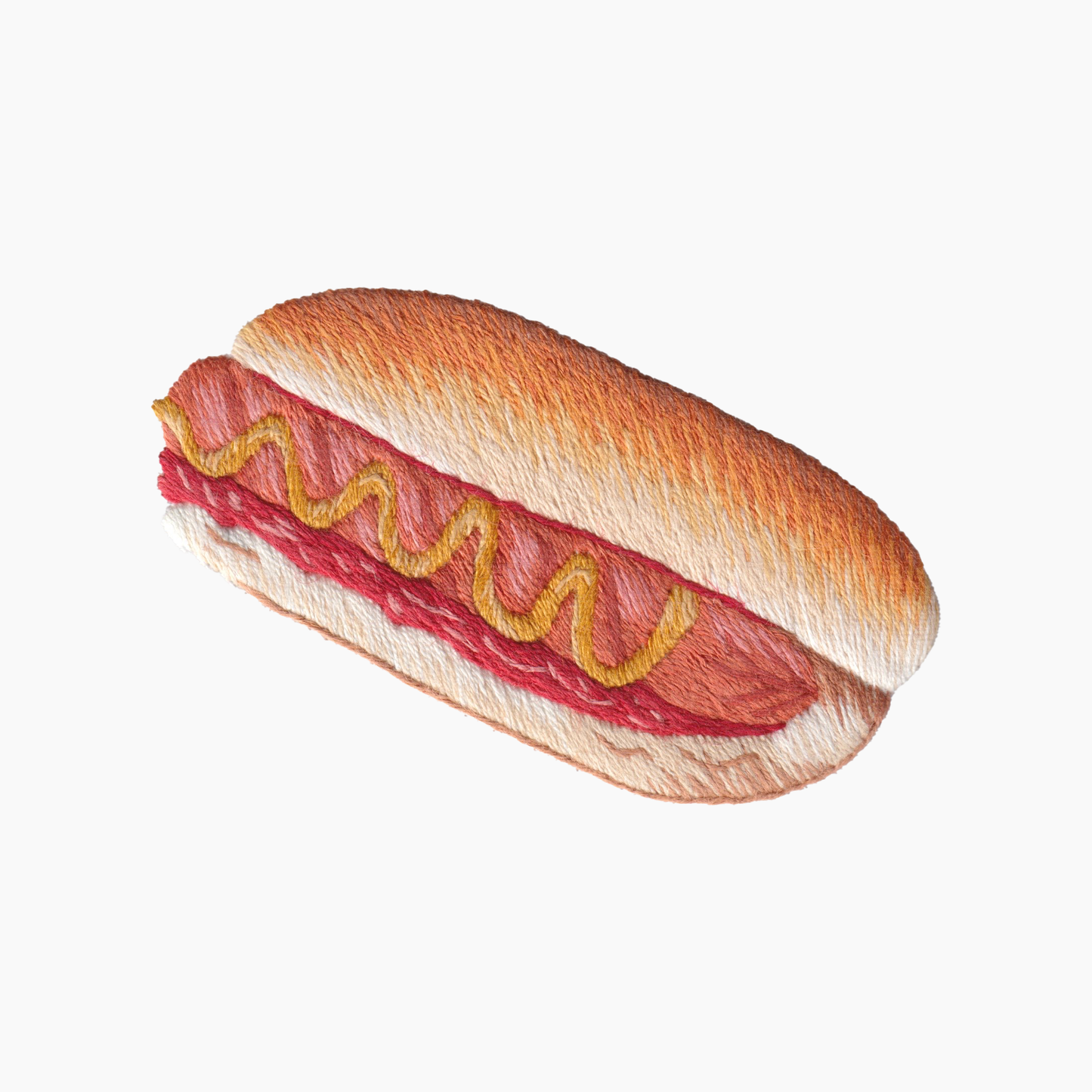 Hand embroidered cotton towel with hot dog on bun with mustard and ketchup on a white background