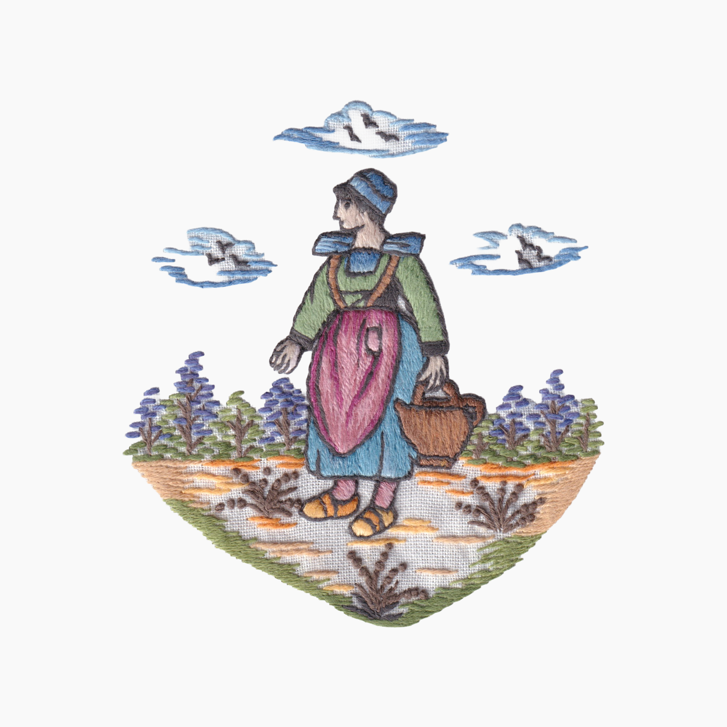 Hand embroidered cotton towel with design of a Quimper style woman with a basket in a garden with birds flying above.