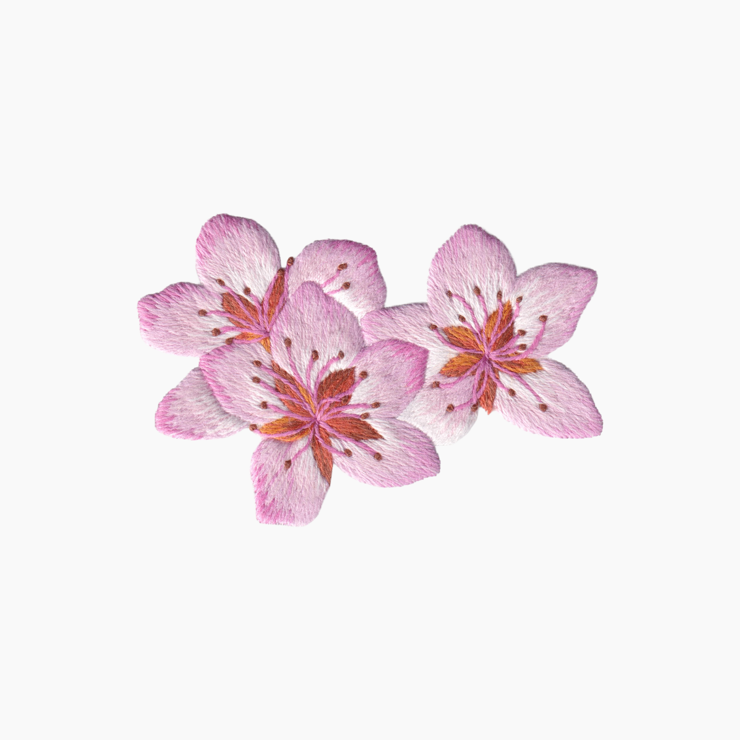 Hand embroidered cotton towel with three pink Japanese sakura flowers with orange centers on a white background