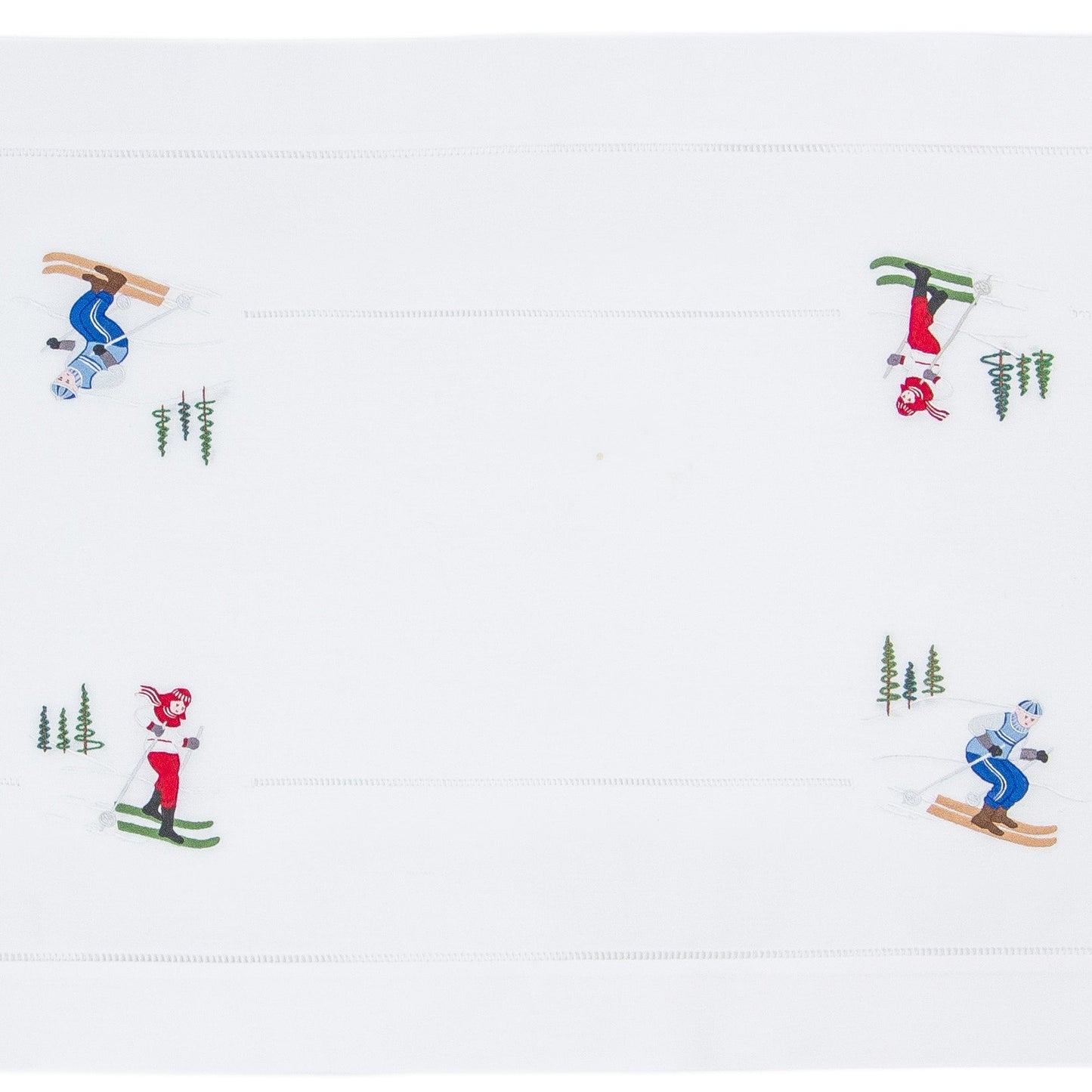 A white table runner with a hemstitch border. Skiers are embroidered in a border around the edge