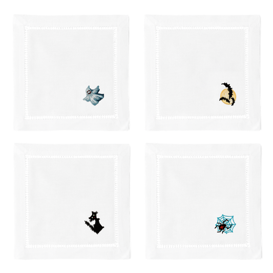4 white cocktail napkins. Embroidered in the bottom right corner of each is a ghost, 3 bats, a black cat, and a spider. 