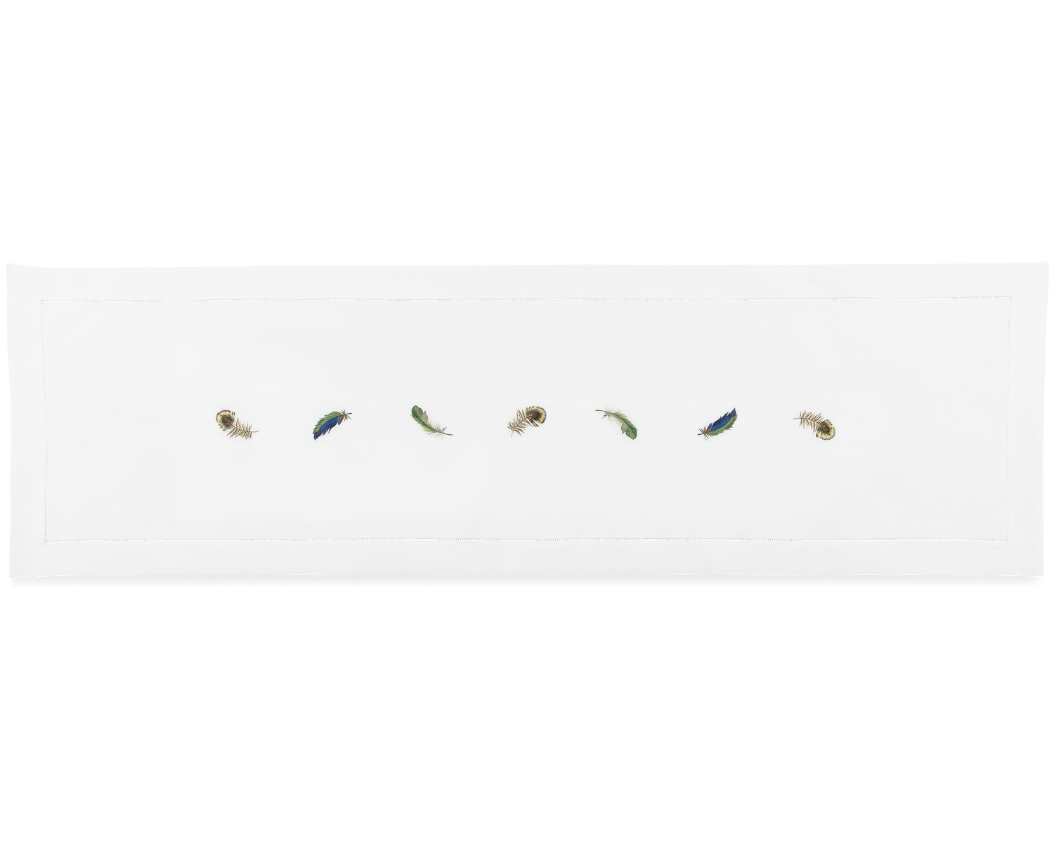 A white runner with a hemstitch border. Embroidered in a line down the center are multiple peacock feathers.