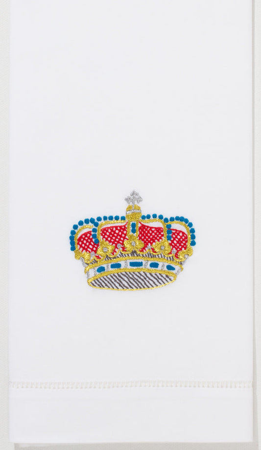 A white hand towel with a hemstitch. A red, blue & gold crown is embroidered in the center