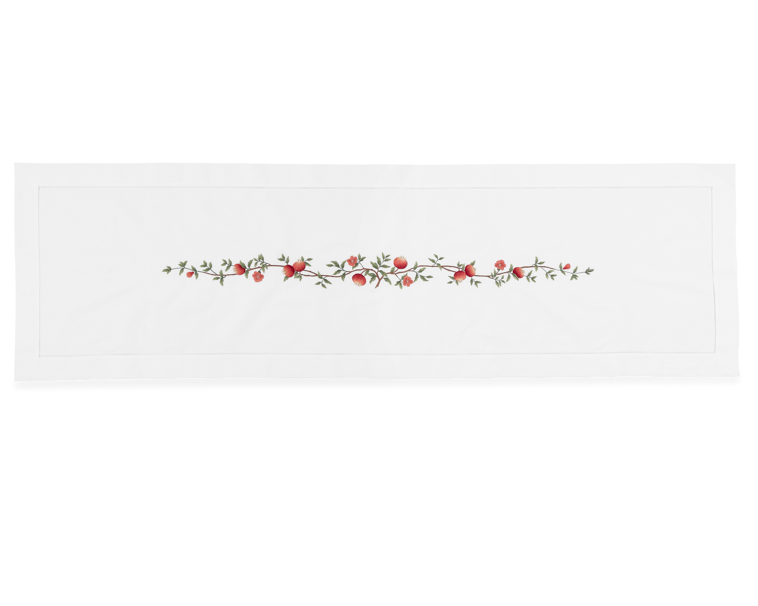 A white table runner with a hemstitch border. A branch of pomegranates extends down a line in the middle.