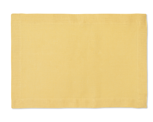 A linen placemat in the color butter