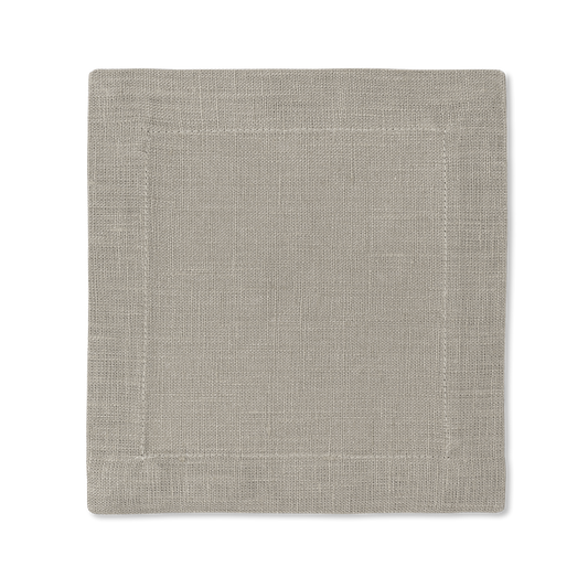 A square linen cocktail napkin in the color sand