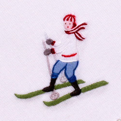 an embroidered female skier wearing white and blue