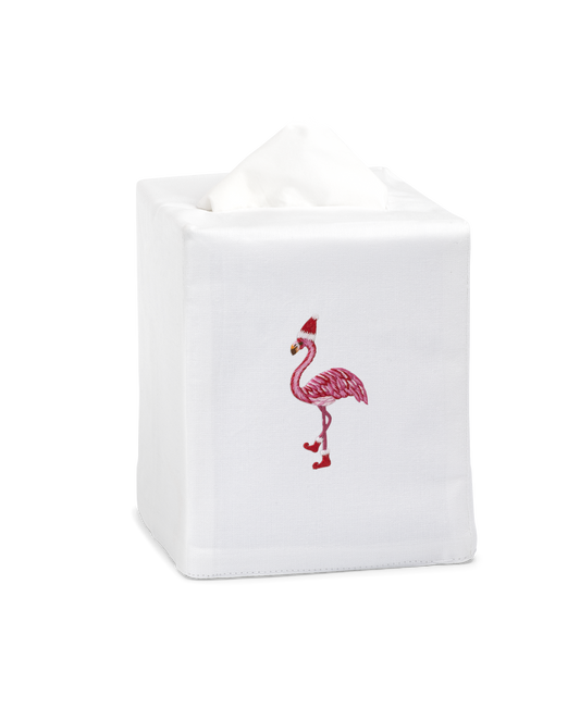 A white tissue cover with a flamingo wearing a santa hat embroidered in the center.