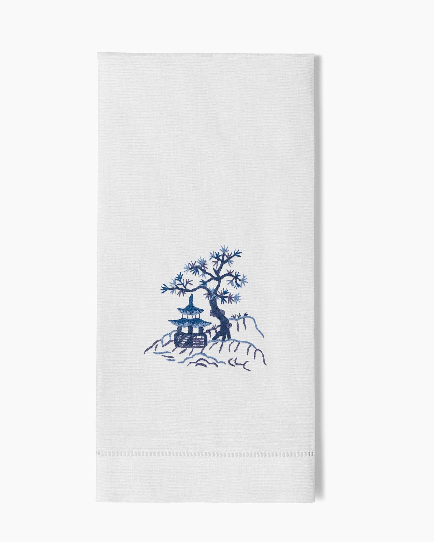 A Canton Blue Hand Towel with a blue tree on it, made by Henry Handwork.