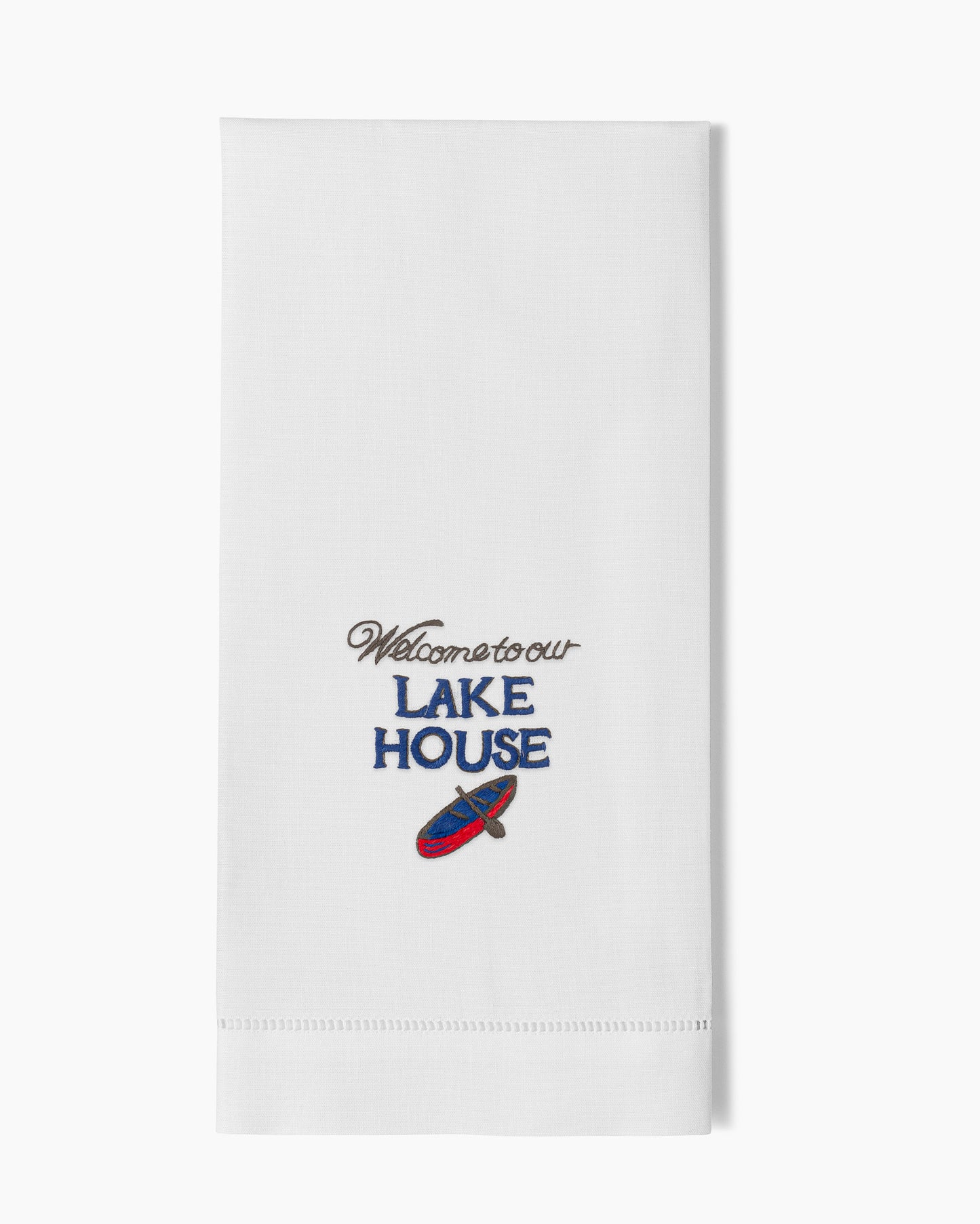 A white Henry Handwork towel that says Welcome to our Lake House.