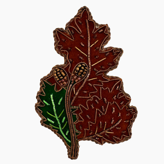 Image of an acorn leaf Christmas ornament with ornate beadwork.