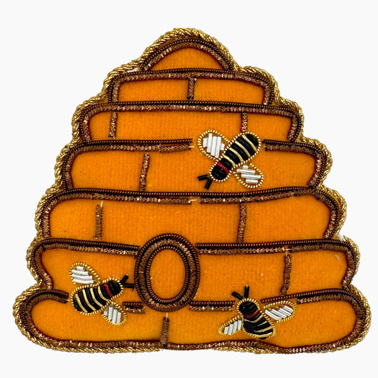 Image of a beehive Christmas ornament with intricate beadwork.