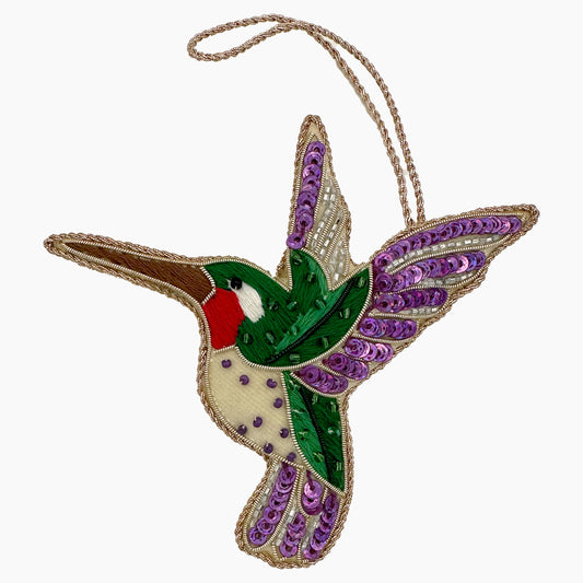 Image of a purple hummingbird Christmas ornament with intricate beadwork. 