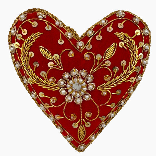 Image of a red heart Christmas ornament with ornate beadwork and pearls.