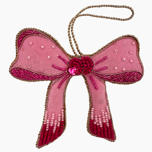 Image of a pink bow Christmas ornament with ornate beadwork.