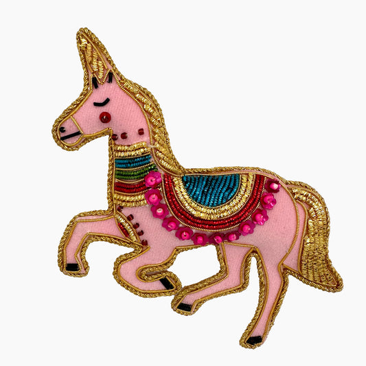 Image of a pink Unicorn Christmas ornament with intricate beadwork. 
