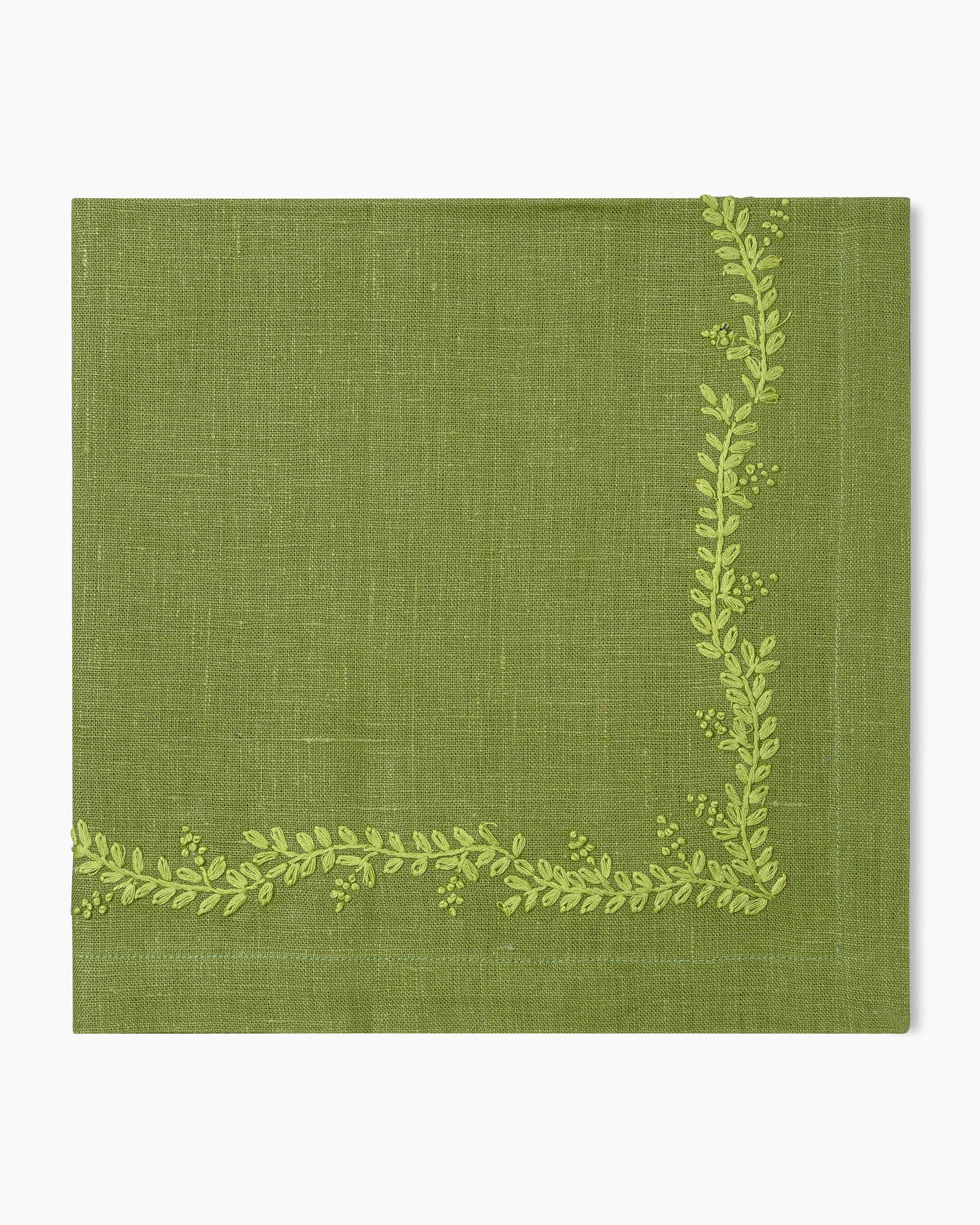 A Henry Handwork Prism Vine Linen Dinner Napkin in 13 colors featuring green leaves.