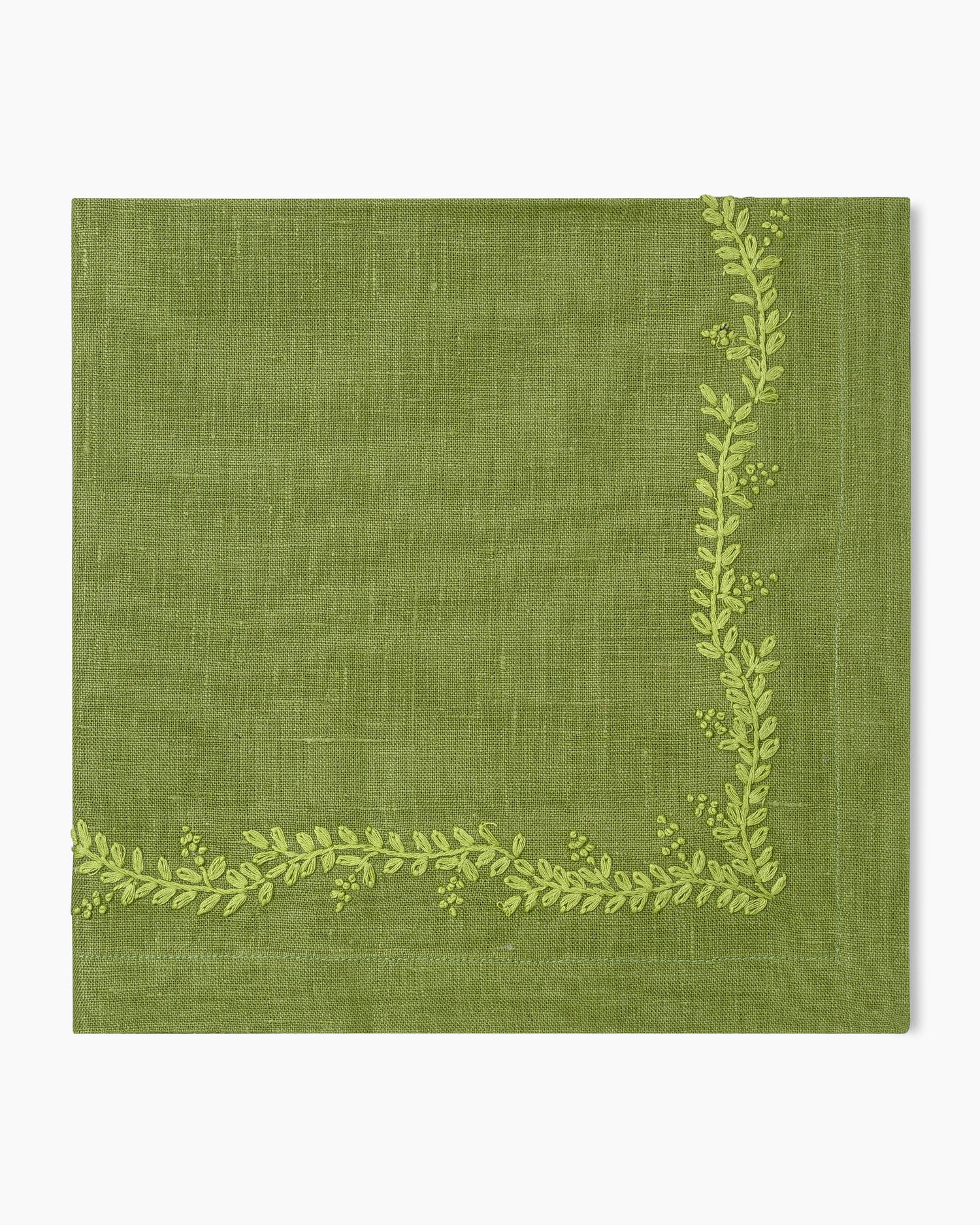 A Henry Handwork Prism Vine Linen Dinner Napkin in 13 colors featuring green leaves.