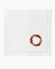 a white napkin with a circle of flowers