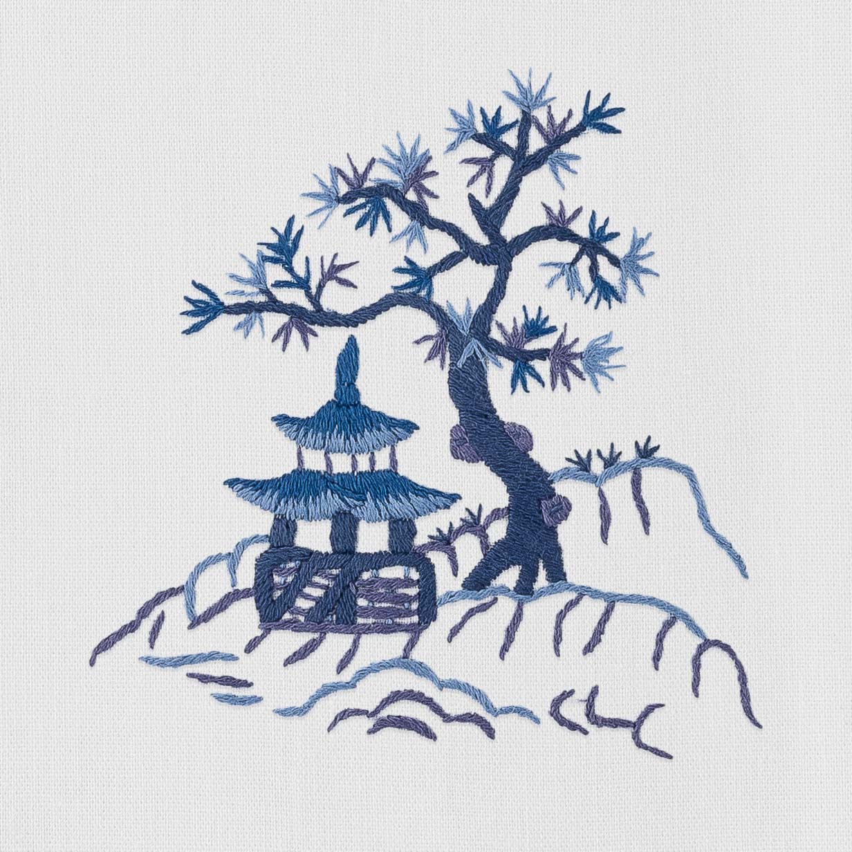 A Canton Blue Hand Towel by Henry Handwork, featuring a chinese tree and pagoda, on a white background.