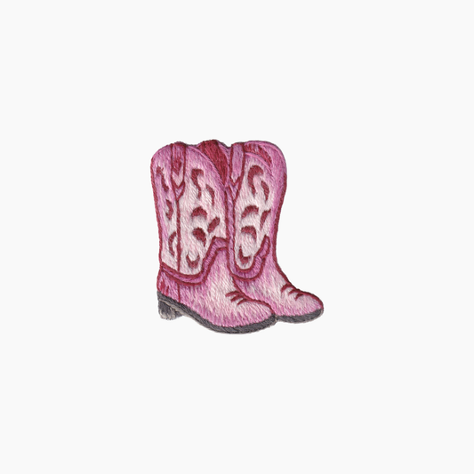 Hand embroidered cotton boutique tissue box cover of pink cowgirl boots with decorative patterns on a white background
