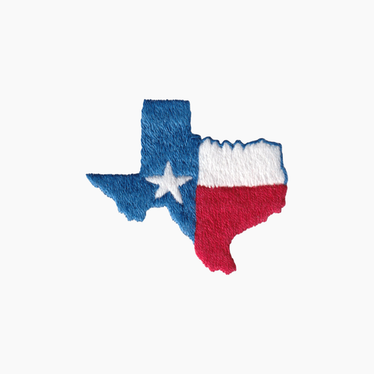 Hand embroidered cotton boutique tissue box cover of the Texas flag on a white background