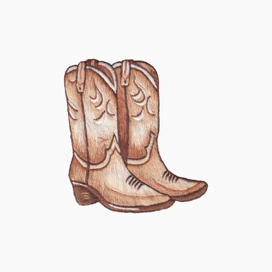 Hand embroidered cotton towel with brown cowboy boots on a white background