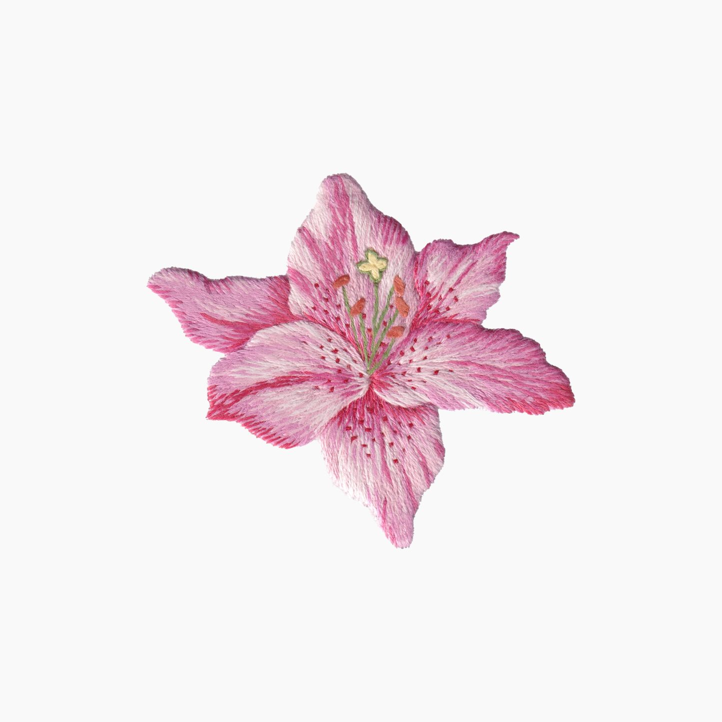 Hand embroidered cotton towel with variegated pink lily flower with a white background