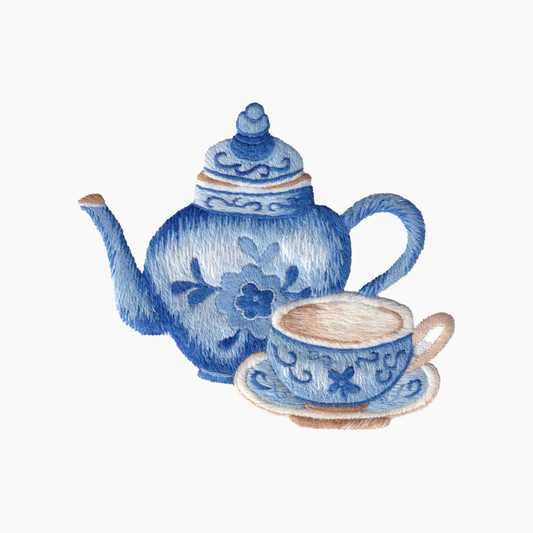 Hand embroidered cotton towel with blue teapot and cup with traditional floral patterns on a white background