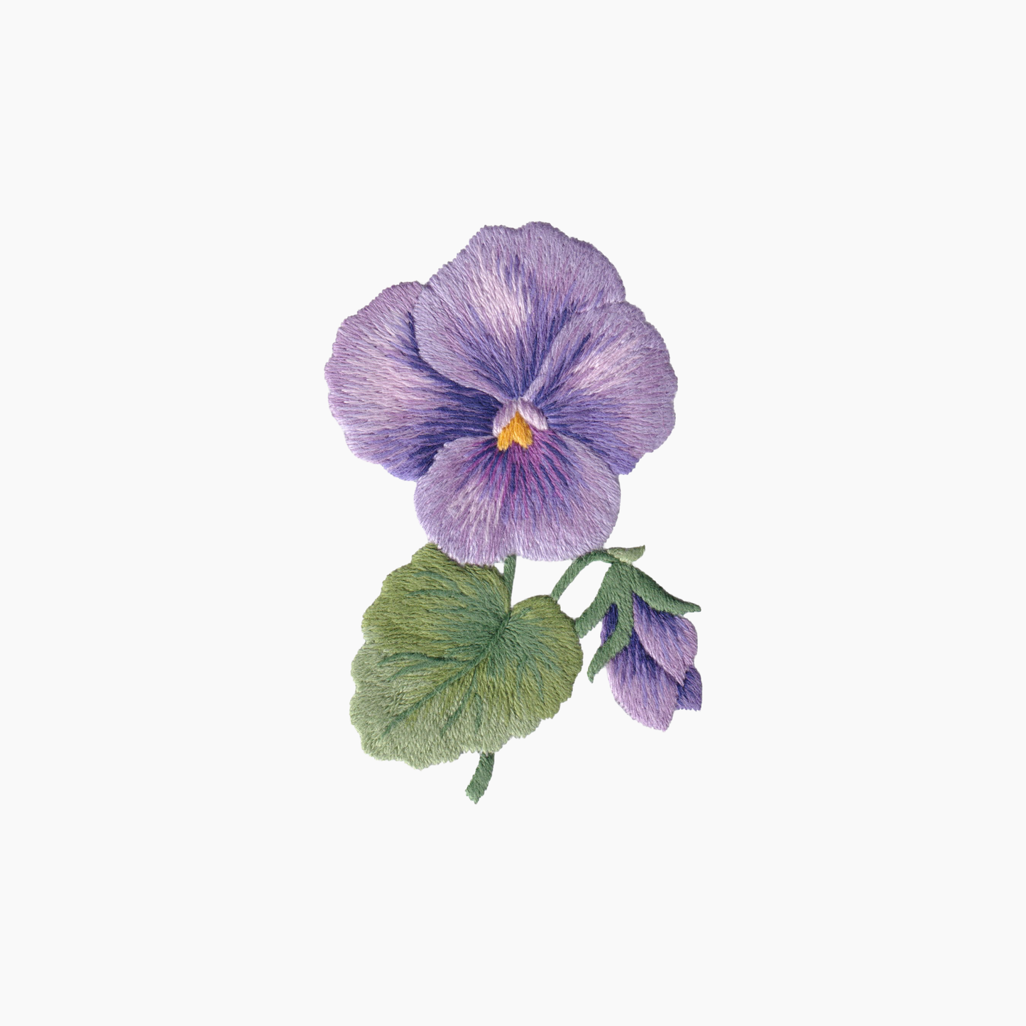 Hand embroidered cotton towel with purple pansy or violet flower with green leaves on a white background