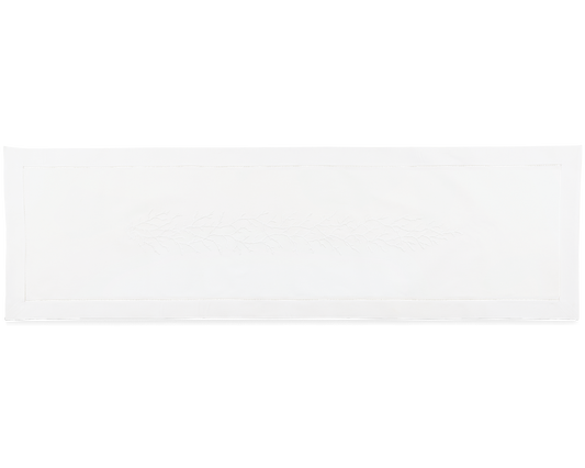 A white table runner. A white piece of coral is embroidered in a line down the middle.