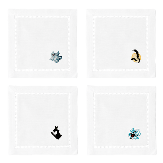4 white cocktail napkins. Embroidered in the bottom right corner of each is a ghost, 3 bats, a black cat, and a spider.
