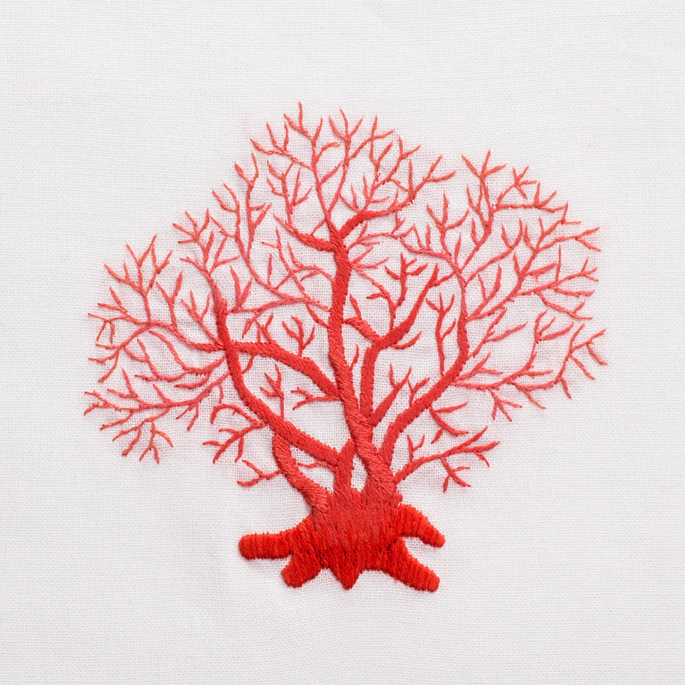 A close up detailed image of the embroidery - A piece of red fan coral.