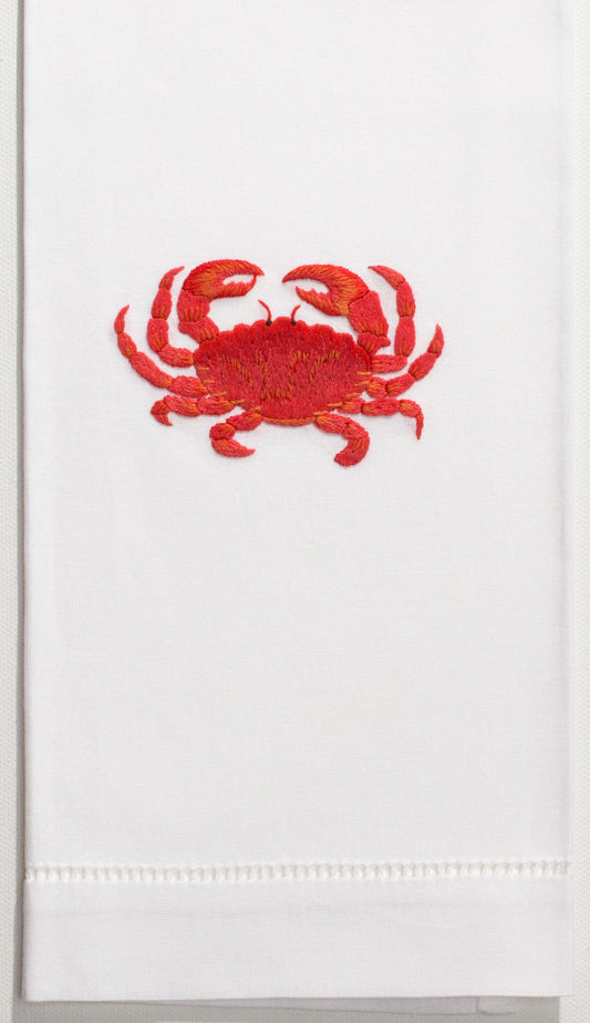 A white hand towel with a hemstitch. A red crab is embroidered in the center.