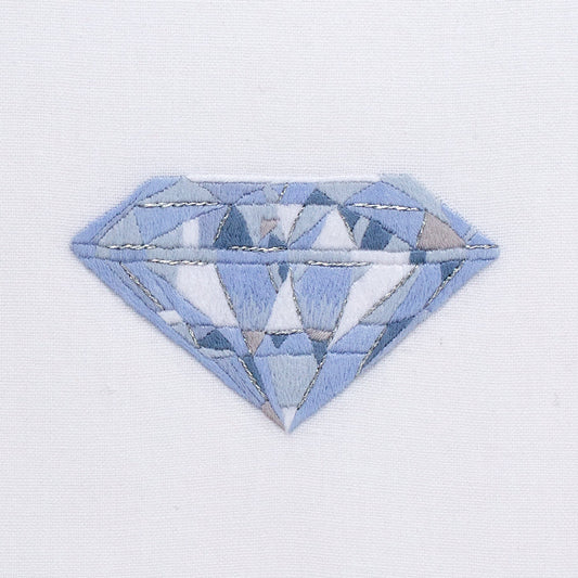 A close up detailed image of the embroidery - A blue and white silvery diamond
