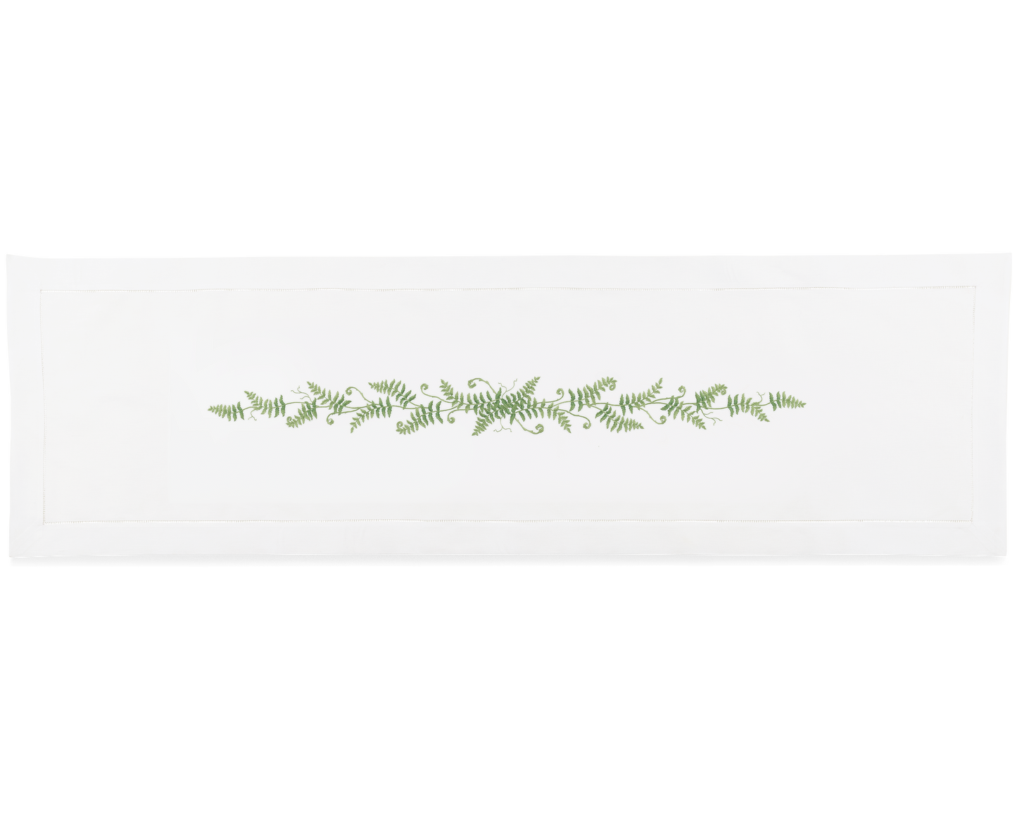 A white runner with a hemstitch border. Curling fern fronds are embroidered in a line down the center.