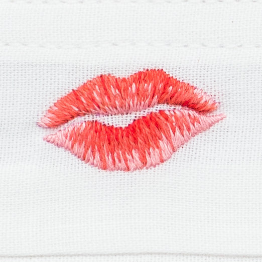 A detailed image of the embroidery - A red & pink lipstick kiss mark