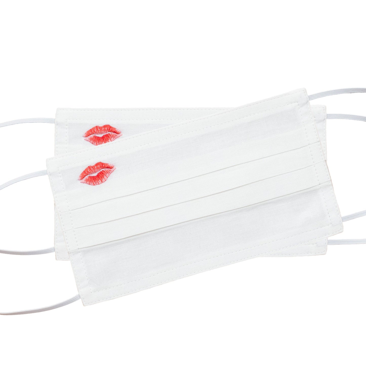 Two white face masks with red & pink lipstick kiss marks in the top left corner of each