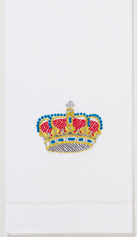 A white hand towel with a hemstitch. A red, blue & gold crown is embroidered in the center