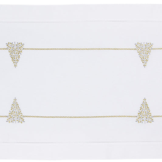 A white table runner with a hemstitch border. Glittering gold and silver christmas trees run down the middle
