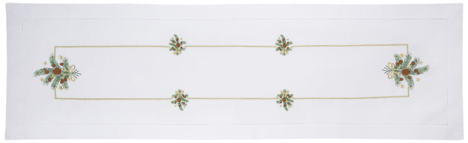 A white table runner with a hemstitch border. Clusters of pinecones and branches extend in a gold border around the middle.
