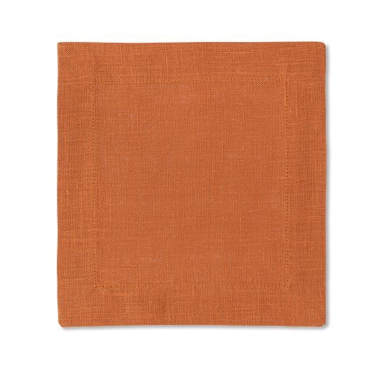 A square linen cocktail napkin in the color tangerine