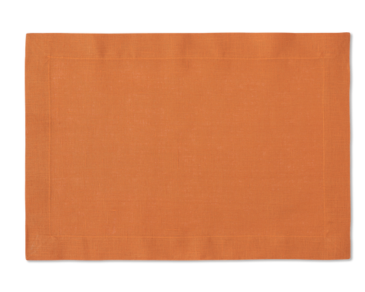 A linen placemat in the color tangerine