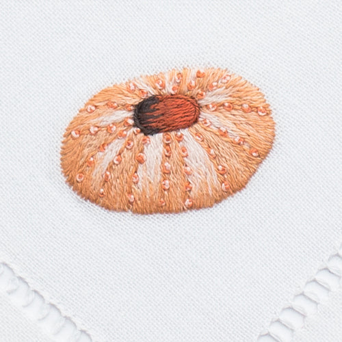 an embroidered sea urchin in the blush color
