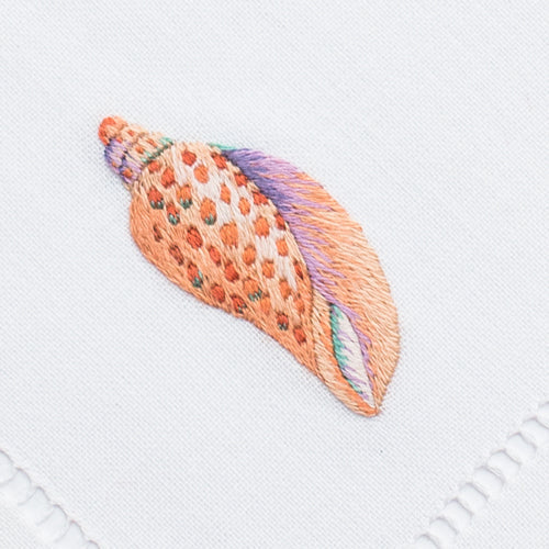 an embroidered cone shell in the blush color